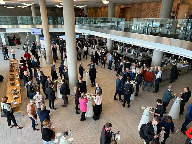 Attendees and speakers networking in the atrium