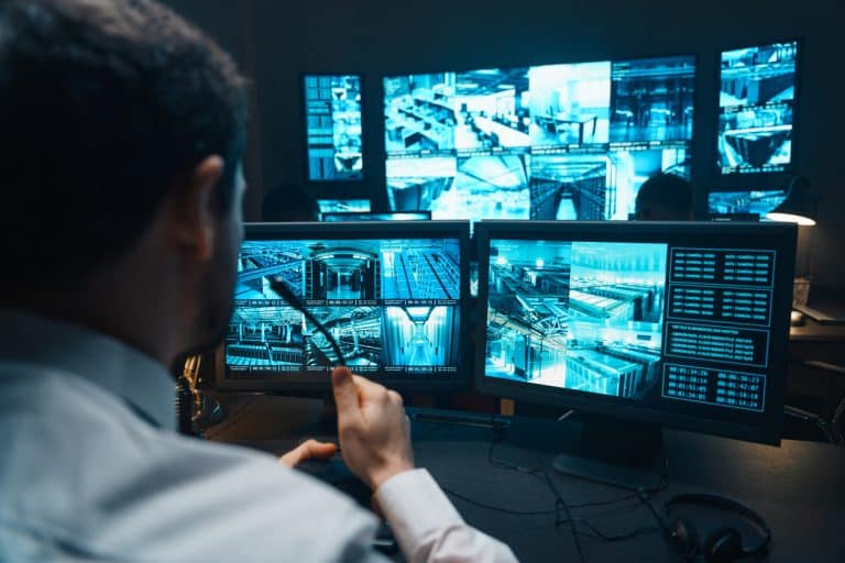 Police officers monitoring a surveillance control centre