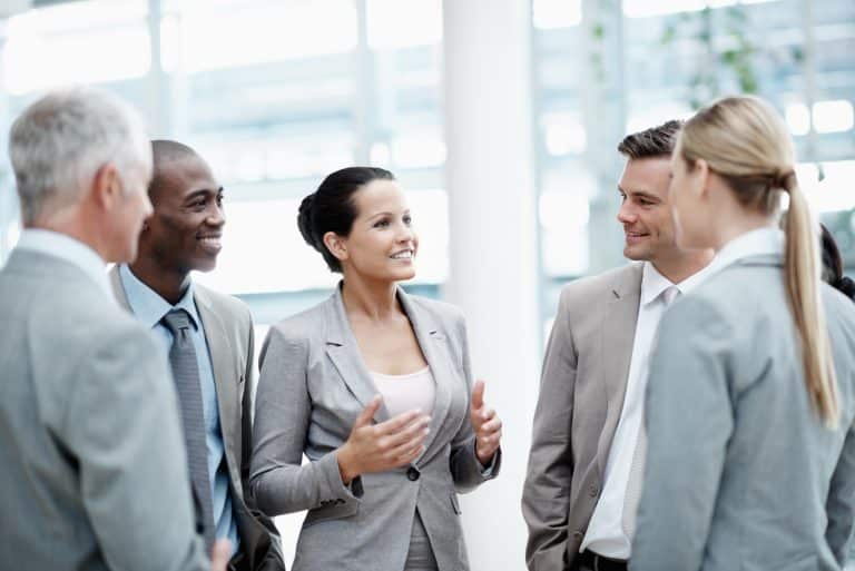 Businesswoman conversing with colleagues in an office