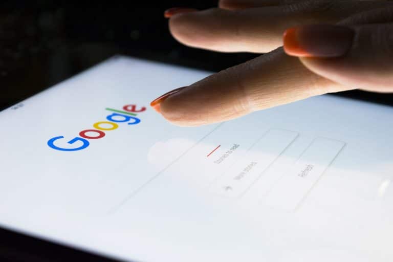 Woman’s hand interacting with tablet at night